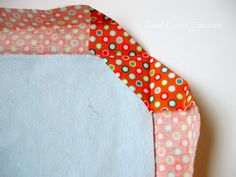 a piece of fabric is laying on top of a table cloth with polka dot designs