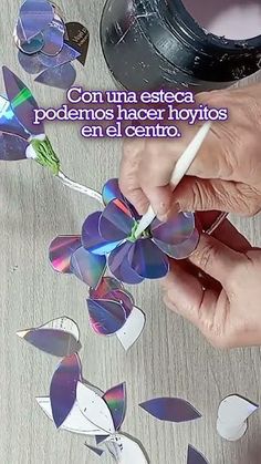 a person is working on some paper flowers