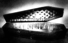 an old mattress sitting on top of a shiny metal bed frame in black and white