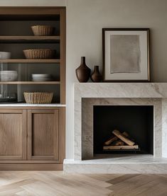 a fireplace in a living room with wooden shelves