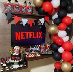 a birthday party with balloons, cake and snacks on the table in front of a netflix sign