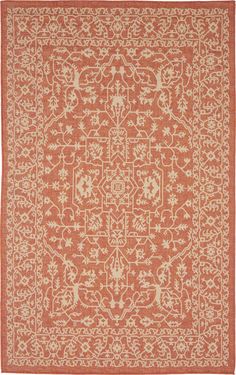 an orange and white rug with floral designs