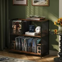 an entertainment center with cd's, cds and other items on it in a living room