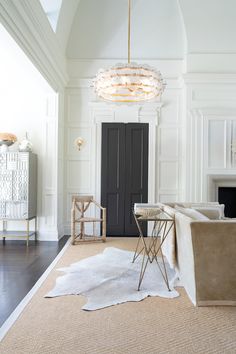 a living room filled with furniture and a chandelier