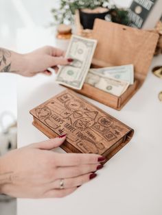 a woman is holding money in her wallet