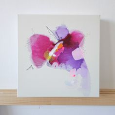 an abstract painting on a white wall above a shelf