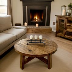 a living room with a couch, coffee table and fire place in the fireplace area