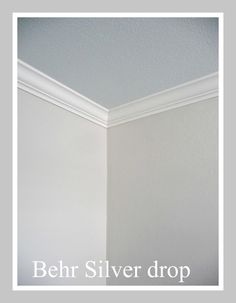 the corner of a room that has been painted white with silver drop paint on it