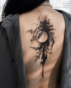 a woman with a clock tattoo on her back