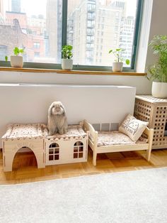 a stuffed animal sitting on top of a wooden bench next to a window