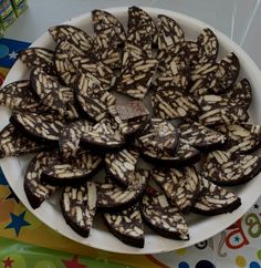 a white plate topped with chocolate covered cookies