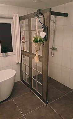 a bathroom with a tub, shower and window