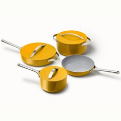 three yellow pots and pans on a white background