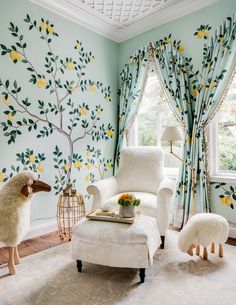 a living room decorated in shades of blue, yellow and white with lemon trees painted on the walls