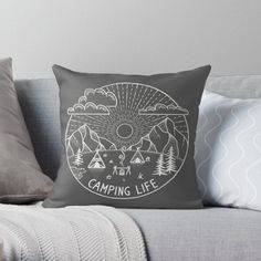 a black and white pillow with the words camping life on it, sitting on a couch