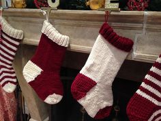 two stockings hanging from a mantel decorated for christmas