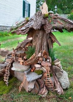 a tree stump that has been made into a fairy house