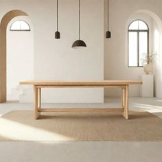 a large wooden table sitting in the middle of a room with two arched doorways