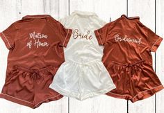 three bridesmaid satin pajamas are shown in red, white and gold colors with matching names on them