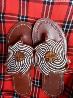 Beautifully designed African beaded sandals, Masai sandals, summer sandals, African sandals Made from fine leather and very fine beads. Available in all sizes. Kindly, using the conversion chart provided in the pictures above, double check your foot size in EUR and US sizes before placing your order. (We have a chart provided on every listing for comparison purposes) Wholesale is available upon request at an agreed discount price. Shipping is via DHL EXPRESS with a GUARANTEED delivery between 3- Beaded Leather Sandals With Single Toe Strap, Beaded Leather Open Toe Sandals, Adjustable Beaded Leather Sandals, Beaded Leather Barefoot Sandals Open Toe, Adjustable Beaded Leather Barefoot Sandals, Beaded Leather Open Toe Barefoot Sandals, Leather Beaded Open Toe Barefoot Sandals, Brown Beaded Leather Sandals, Leather Beaded Sandals For Festival