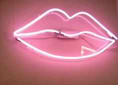 a pink neon sign with a white light on it's side and a lipstick shaped object in the middle