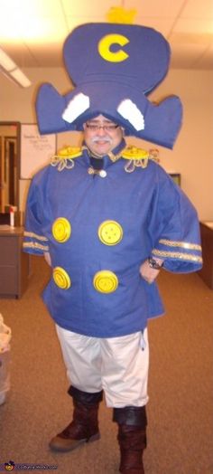 a man in a blue bear costume standing in an office