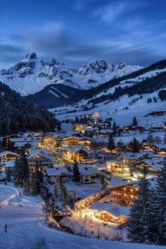 a snowy mountain town lit up at night