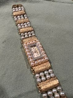 "This beautiful vintage wrist watch features four columns of pearls threaded through 14K gold scroll beads.  The watch face is small and rectangular, surrounded by 18 small diamonds.  This piece is signed in the traditional Lucien Piccard arc and bears a serial stamp \"C2244.\"   Unknown if the watch works but can easily be tended to by an experienced watchmaker.  Please ask questions! I am happy to answer as best as I can.  If you are familiar with this brand, you know this price is an absolute bargain.  **Accepting offers This stunning piece is from an estate collection of a family friend.  She was a lovely fashion model, a world traveler, and with her most popular years in the 80s and 90s.  She found home in her later years in beautiful Colorado.  She had an eclectic style and it's time Vintage Wrist Watch, Lovely Fashion, Family Friend, Pearl Flower, Eclectic Style, Women Wrist Watch, Diamond Watch, World Traveler, Fashion Model