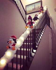 stuffed animals are lined up on the banisters in this hallway decorated for christmas