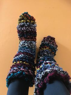 the legs are covered in multicolored crochet