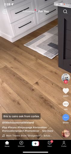 the app is showing an image of a kitchen with white cabinets and wood flooring