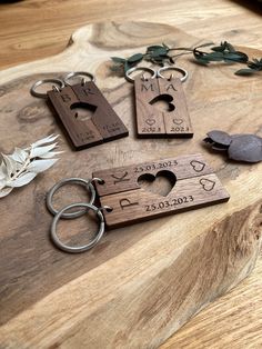 several wooden keychains are arranged on a table