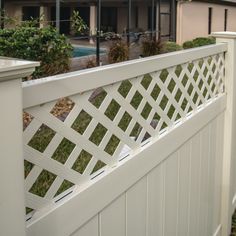 a white fence that is next to a house