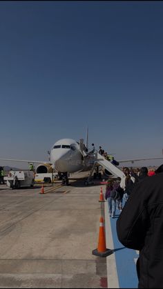 people are lined up to board an airplane