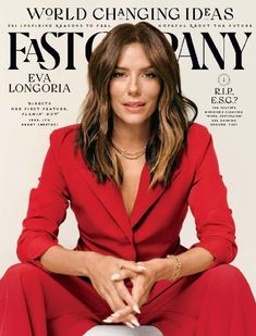 a woman sitting on top of a magazine cover wearing a red suit and gold jewelry