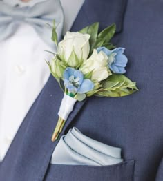 a boutonniere with blue and white flowers on it's lapel