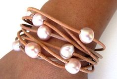 PEARL WRAP BRACELET ~ Multi Strand Leather and freshwater pearl bracelet. 8 Strands of Natural leather, 8 beautiful iridescent freshwater pink pearls, stainless steel magnetic clasp. A statement piece! COLOR Leather & COLOR Pearl/WRIST Size ~ from the drop down menu * WRIST SIZES ~ Small 7 inches Medium 8 inches Large 9 inches There are NO refunds or exchanges for Magnetic clasp designs. HOW TO MEASURE YOUR WRIST - Take a piece of string, wrap snug around your wrist, hold up to a ruler. Your bra Pink Pearl Bracelet, Jewelry Pearls, Pearl Cuff Bracelet, Pearl Beach, Pearl Anklet, Pearl Cuff, Leather Jewellery, Bracelet Pearl, Pearl Bangle