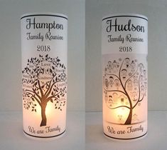 two wine bottles with the names of family reunions on them are lit by candles