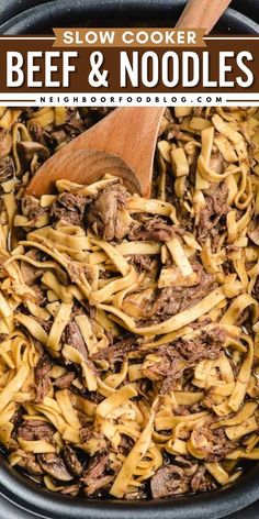 slow cooker beef and noodles in a black bowl with a wooden spoon on the side