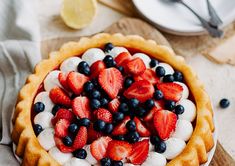 a pie with strawberries and blueberries on top