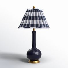 a blue lamp with a checkered shade on the base and a gold - plated base