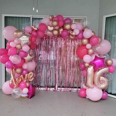 pink and gold balloon arch with love balloons