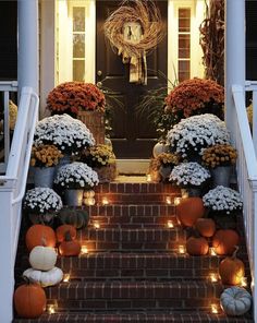 front steps decorated with pumpkins and flowers