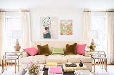 a living room filled with lots of furniture and decor on top of a hard wood floor