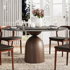 a round table with chairs around it in front of a window and flowers on the table