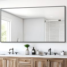 a bathroom with two sinks and a large mirror