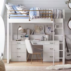 a white loft bed with desk and chair in a bedroom next to a wall mounted mirror