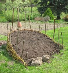 a garden bed made out of sticks and dirt