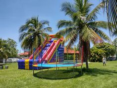 an inflatable water slide and palm trees