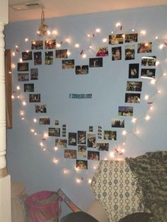 a heart shaped photo frame with lights hanging from it's sides and pictures on the wall